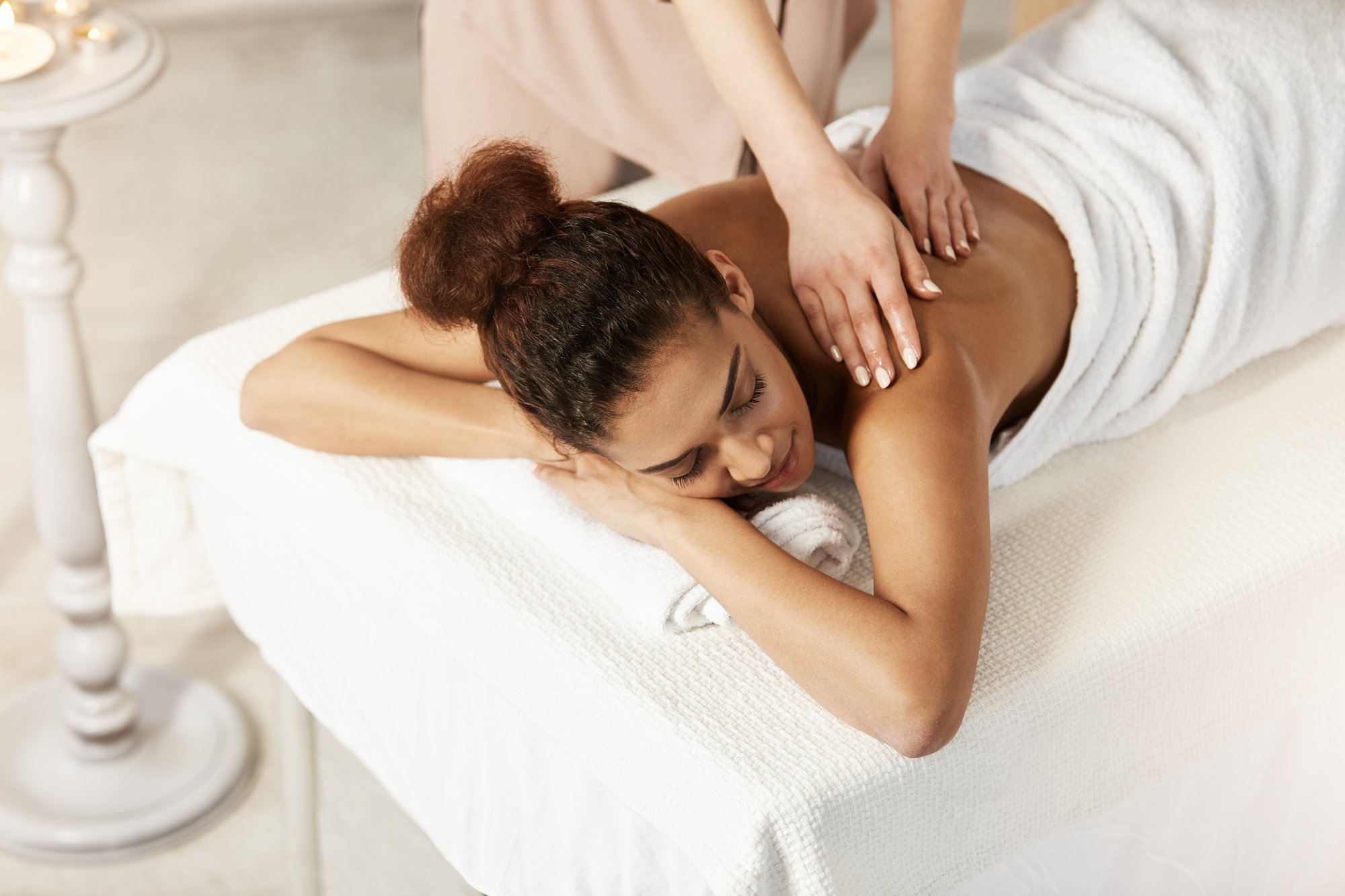 beautiful-african-woman-smiling-enjoying-massage-with-closed-eyes-spa-salon