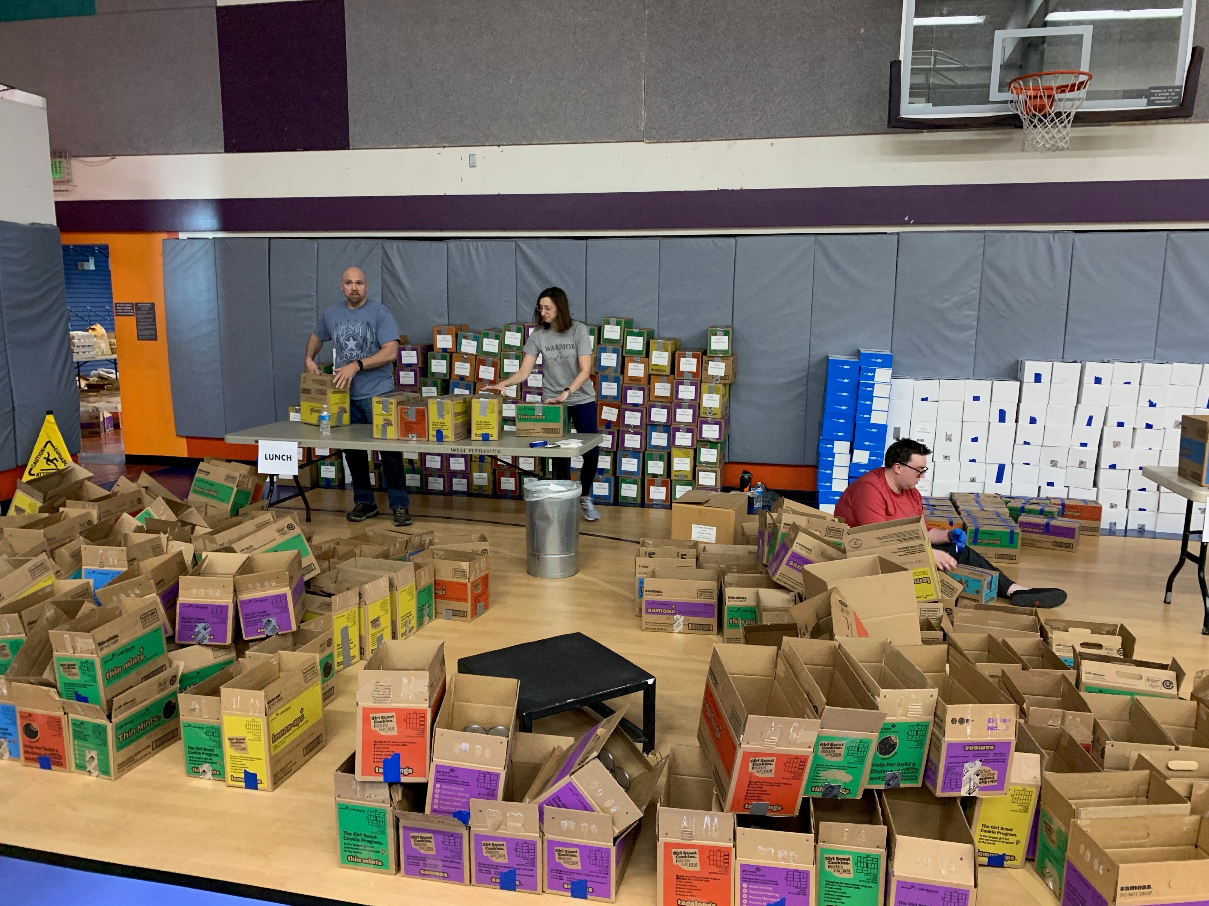 Members of The Alaska Club packing lunches for children in the community 