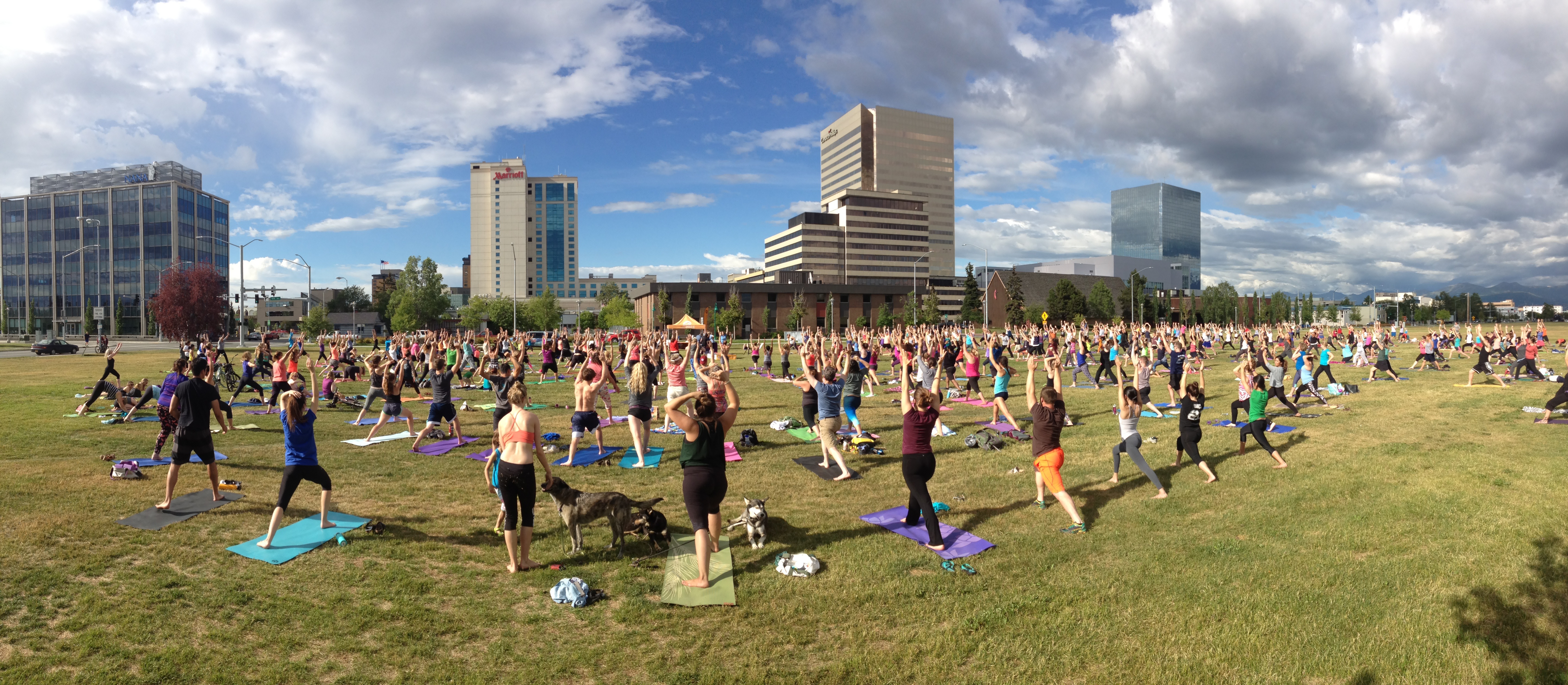 large group of people at Yoga In The Park hosted by The Alaska Club