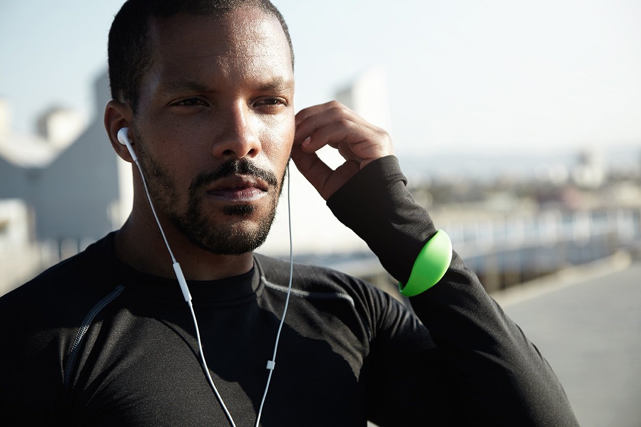 Man prepping for a workout and wearing a fitness watch 