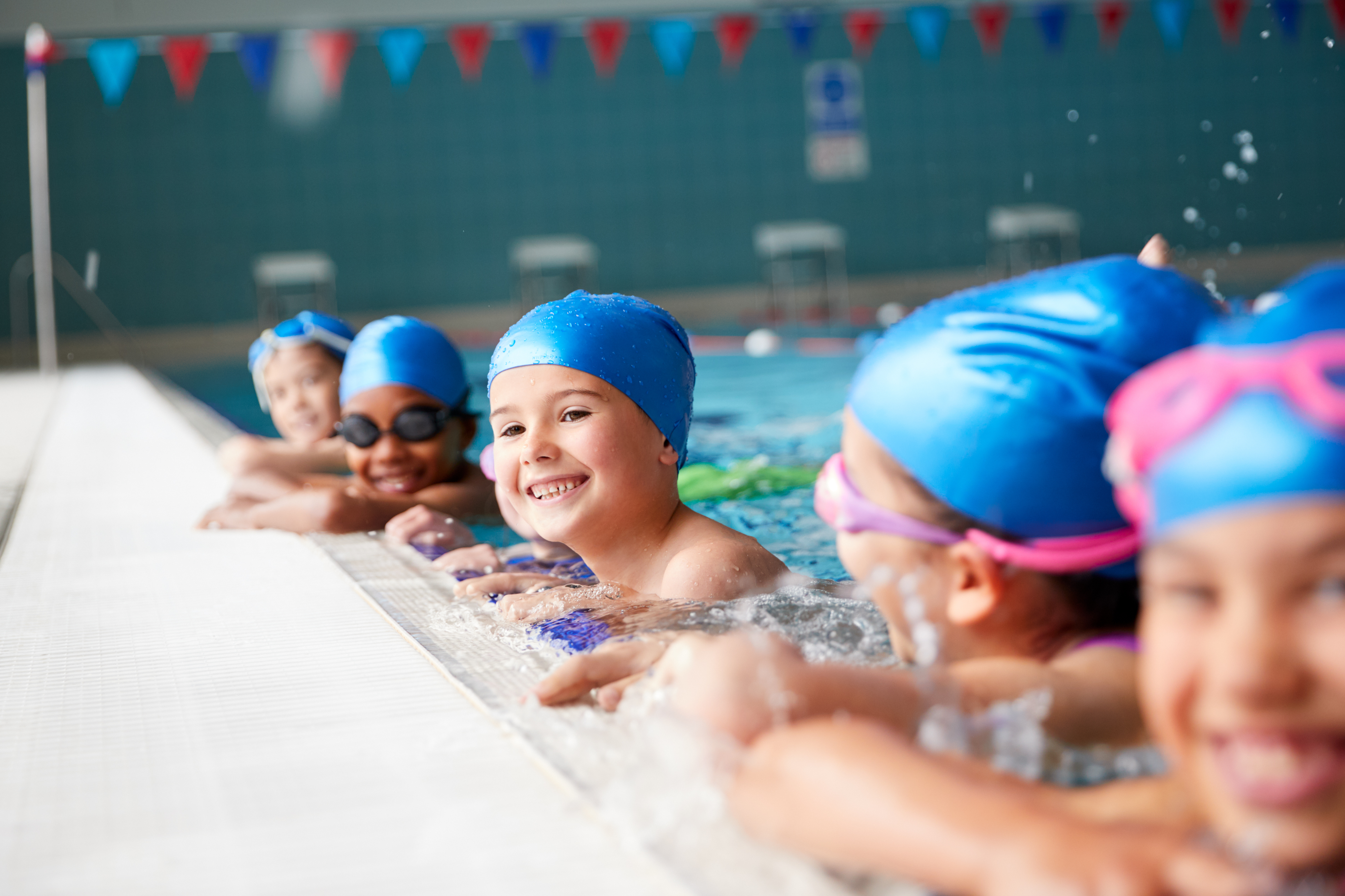 group of children in pool smiling