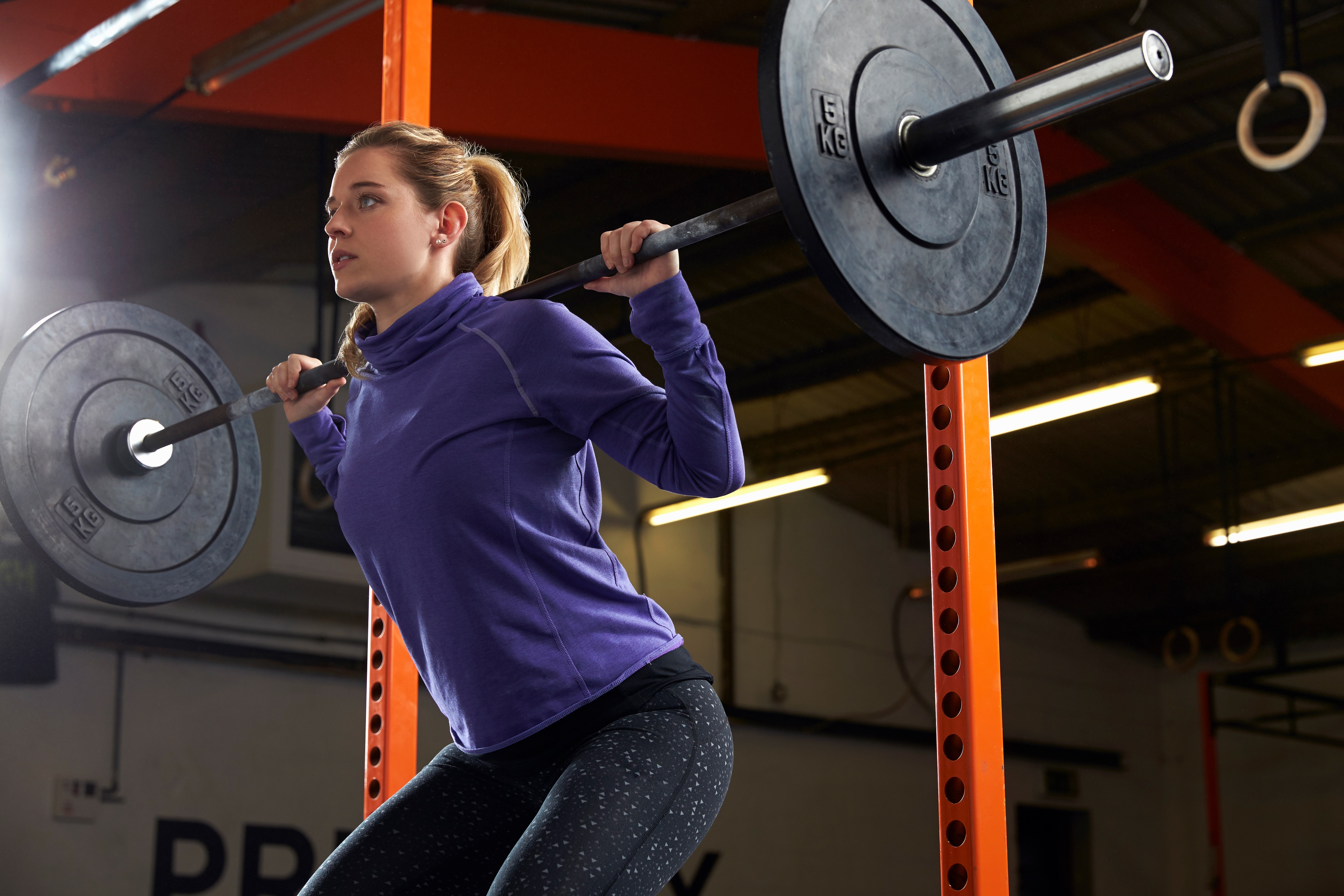 Woman exercising with compound strength movements